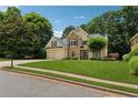 Charming two-story home with a manicured lawn, mature trees, and a two-car garage at 1125 Fairview Club Cir, Dacula, GA 30019