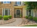 Inviting front entrance with stone accents, decorative wreath, and manicured landscaping at 1125 Fairview Club Cir, Dacula, GA 30019
