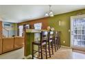 Open breakfast bar area with seating for four, a view to the backyard and adjacent living space at 1441 Saint George Pl, Conyers, GA 30012
