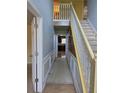 Hallway with decorative molding and a view of the kitchen at 1441 Saint George Pl, Conyers, GA 30012