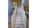 Carpeted stairway with white railing leads to the second floor of this lovely home at 1441 Saint George Pl, Conyers, GA 30012