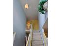 Carpeted stairway with high ceilings and a decorative light fixture at 1441 Saint George Pl, Conyers, GA 30012
