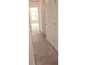 Bright hallway featuring neutral carpet and a partially viewed window at the end at 116 Ventura Trl, Stockbridge, GA 30281