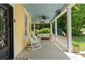 Inviting front porch with rocking chairs, swing, and a ceiling fan, perfect for relaxing outdoors at 161 N Barton St, Norcross, GA 30071