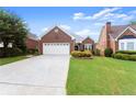 Inviting brick home showcasing a well-kept lawn and beautiful landscaping at 2323 Blackberry Ct, Snellville, GA 30078