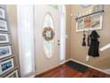 Welcoming foyer with hardwood floors and elegant oval glass front door creates a warm entry at 241 Lost Lake Way, Villa Rica, GA 30180