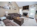 Cozy living room with fireplace, comfortable seating, and ample natural light, creating an inviting atmosphere at 241 Lost Lake Way, Villa Rica, GA 30180