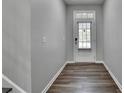 Inviting entryway with wood-look flooring, freshly painted walls, and a glass-paneled front door at 315 Duval Dr, Alpharetta, GA 30009