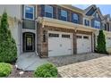 A townhome with a brick facade, two-car garage, and a well-manicured lawn at 315 Duval Dr, Alpharetta, GA 30009