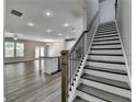 Open-concept living space with hardwood floors, modern staircase, and ample natural light at 315 Duval Dr, Alpharetta, GA 30009