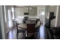 Open kitchen and dining area featuring stainless steel appliances, granite countertops, and ample cabinet space at 3750 Richmond Bnd, Lithonia, GA 30038