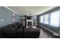Inviting living room featuring a fireplace, large windows, and a comfortable seating area at 3750 Richmond Bnd, Lithonia, GA 30038