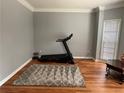 Bright exercise room with wood floors, a treadmill, and natural light at 134 Carolinas Way, Fayetteville, GA 30215