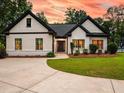 Attractive single-story home featuring a well-manicured lawn and contemporary black-framed windows, radiating curb appeal at 3640 Pollys Blf, Cumming, GA 30028