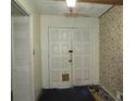 View of the home's entryway featuring double doors, floral wallpaper, and tile flooring at 5114 Fawn Se Trl, Mableton, GA 30126