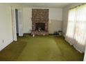 View of the living room showcasing a brick fireplace, carpet, and natural light at 5114 Fawn Se Trl, Mableton, GA 30126