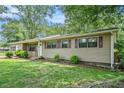 Inviting single-story home boasting a lush, green lawn and thoughtfully designed landscaping at 96 S Forty Pass S, Hiram, GA 30141