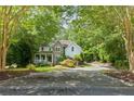 Stately home with stone and siding facade complemented by a long driveway and verdant landscaping at 1788 River Bluff Vw, Duluth, GA 30097