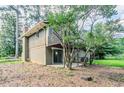 Backyard featuring a small deck, a concrete patio, and mature trees at 2110 Redbud Sw Ct, Marietta, GA 30008