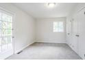 Bright bedroom featuring carpeted floor, neutral paint, a window, and closet at 2110 Redbud Sw Ct, Marietta, GA 30008