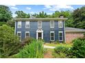 Traditional two-story home with blue siding, manicured lawn, and mature landscaping at 2340 Castleridge Ct, Tucker, GA 30084