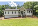 Charming renovated home with a gabled roof, front porch and manicured front lawn at 243 Hickory Way, Canton, GA 30115
