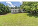 Large, well-manicured front yard with a view of the home's exterior at 243 Hickory Way, Canton, GA 30115