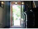 Elegant foyer featuring brick accents, an arched entryway, and a decorative console table at 7825 Crownpoint Dr, Alpharetta, GA 30005