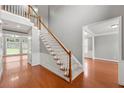 Bright foyer with hardwood floors and staircase leading to the second floor at 1999 Barrett Knoll Nw Cir, Kennesaw, GA 30152