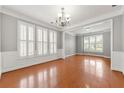 Bright living room with hardwood floors and large windows with wooden shutters at 1999 Barrett Knoll Nw Cir, Kennesaw, GA 30152