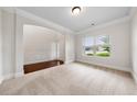 Spacious carpeted room showcasing large windows, an archway and a neutral color scheme for a bright and inviting space at 3865 Rifflepool Ct, Douglasville, GA 30135