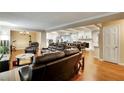 An open concept design features a living room and dining area with a modern kitchen and hardwood flooring at 537 Raven Springs Trl, Stone Mountain, GA 30087