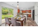 Eat-in kitchen featuring cherry cabinets, tile backsplash, and stainless steel appliances at 926 Hawthorn Ln, Grayson, GA 30017
