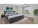 Spacious main bedroom with a plush bed, neutral colors, and large window at 926 Hawthorn Ln, Grayson, GA 30017