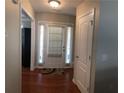 Bright foyer featuring hardwood floors, a white front door with sidelights, and a convenient coat closet at 3299 Arbor Oaks Dr, Snellville, GA 30039