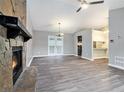 Spacious living room featuring a stone fireplace, modern floors, and French doors at 3918 S Creek Ct, Stone Mountain, GA 30083