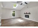Spacious living room with high ceilings, skylight and a modern fireplace at 558 Newlin Ct, Lawrenceville, GA 30046
