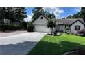 Attractive single-story home features a well-manicured lawn, mature landscaping, and a two-car garage at 1570 Cedars Rd, Lawrenceville, GA 30045
