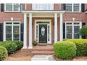 Charming front porch with brick accents and decorative columns, enhancing the home's curb appeal at 1140 River Laurel Dr, Suwanee, GA 30024