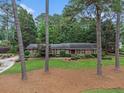 Traditional brick home with lush lawn and mature trees, showcasing its timeless elegance at 2221 Fairoaks Rd, Decatur, GA 30033