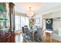 Formal dining room featuring a modern chandelier, mirrored table, and ample light at 4241 Hampton Mill Pkwy, Douglasville, GA 30135