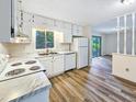 Well-lit kitchen featuring bright cabinets, modern appliances, and easy access to living area at 1596 Allgood Rd, Stone Mountain, GA 30083