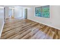 Bright living room featuring sleek flooring and natural light from a large window at 1596 Allgood Rd, Stone Mountain, GA 30083