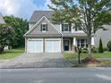 Lovely two-story home featuring a two-car garage and manicured front lawn at 2481 Southhaven Ln, Buford, GA 30519