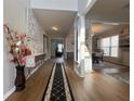 Inviting hallway featuring hardwood floors, elegant decor, and access to multiple rooms at 2481 Southhaven Ln, Buford, GA 30519