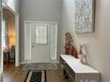 Bright and airy hallway with hardwood floors, decorative accents, and a welcoming entrance at 2481 Southhaven Ln, Buford, GA 30519