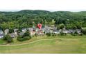 A picturesque neighborhood featuring well-manicured lawns, surrounded by lush greenery and a serene lake at 5345 Glenhaven Dr, Cumming, GA 30041