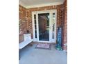 Cozy front porch with bench and 'Home Sweet Home' sign at 969 Golden Meadows Ln, Loganville, GA 30052