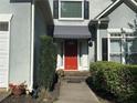 Welcoming front entrance with a bright red door and manicured landscaping at 1469 Crescent Walk, Decatur, GA 30033