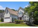 Charming two-story home with a well-maintained lawn, a two-car garage, and mature trees at 1469 Crescent Walk, Decatur, GA 30033